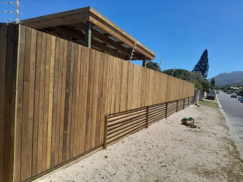 Long timber boundary fence along a street in Fish Hoek